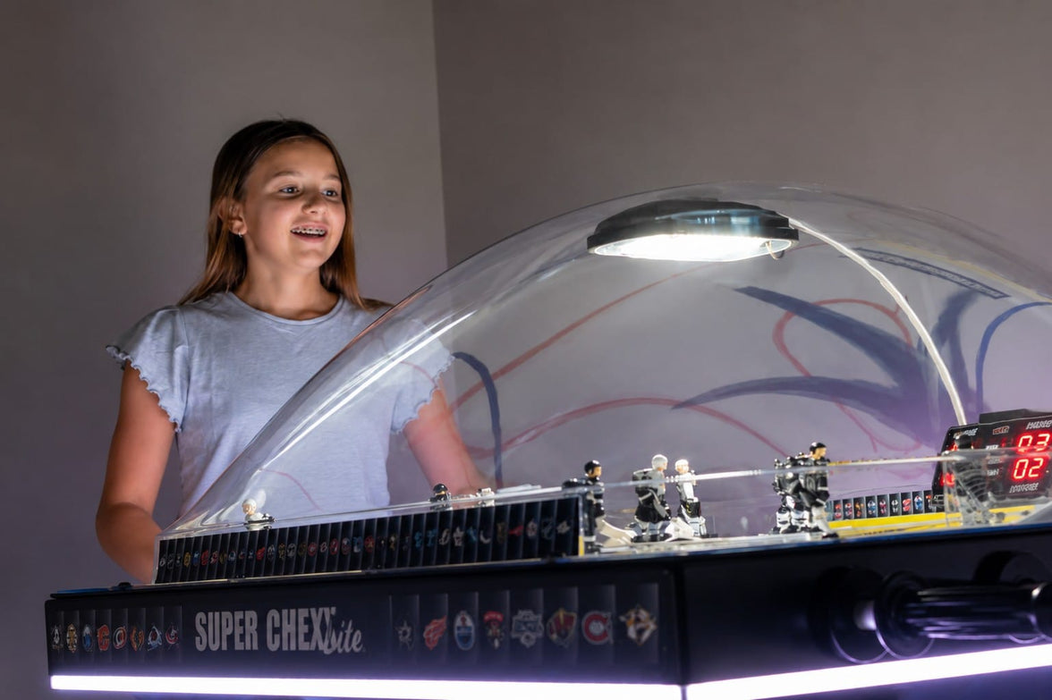 Girl playing NHL Super Chexx Lite bubble hockey