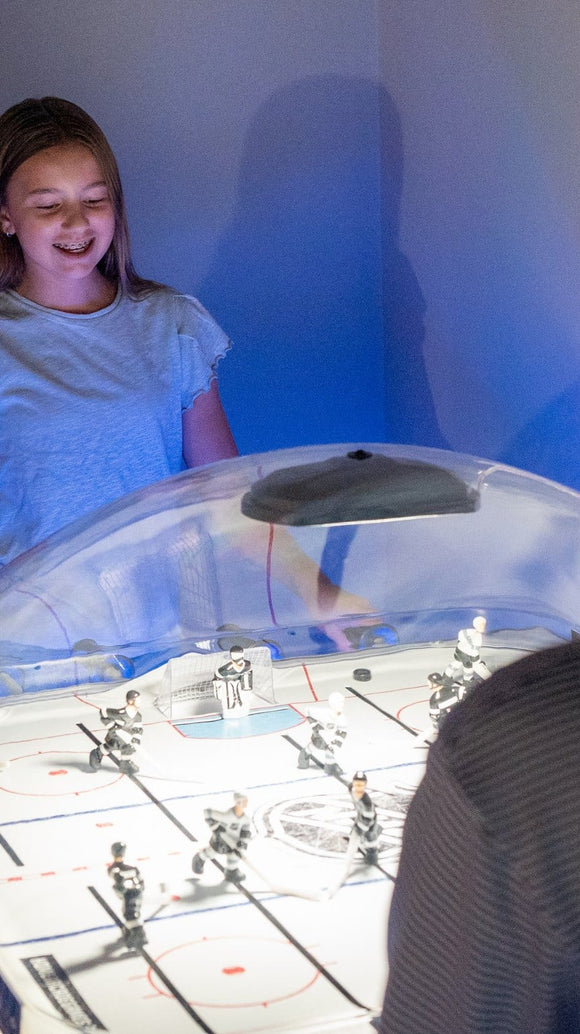 Girl playing Super Chexx Lite in a game room