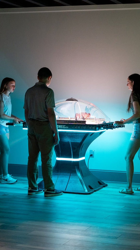 Family playing Super Chexx Lite with LED lights
